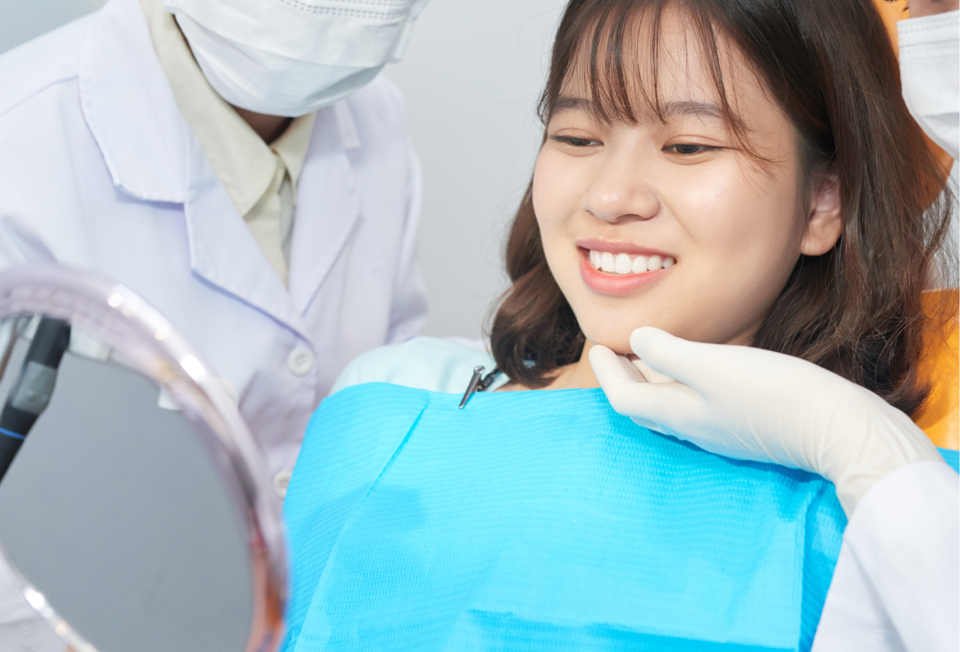 Happy female patient smiling satisfied at the dentist